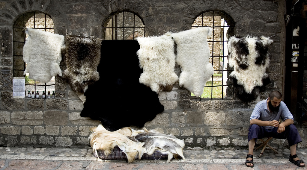 A man selling furs on the street