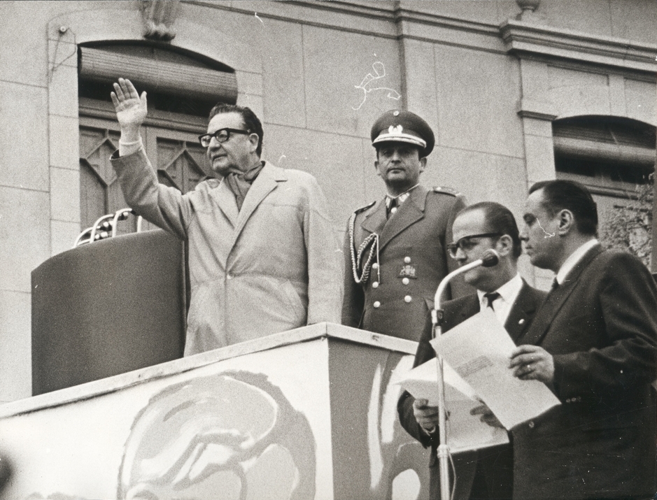 A photo of Salvador Allende waving to a crowd.