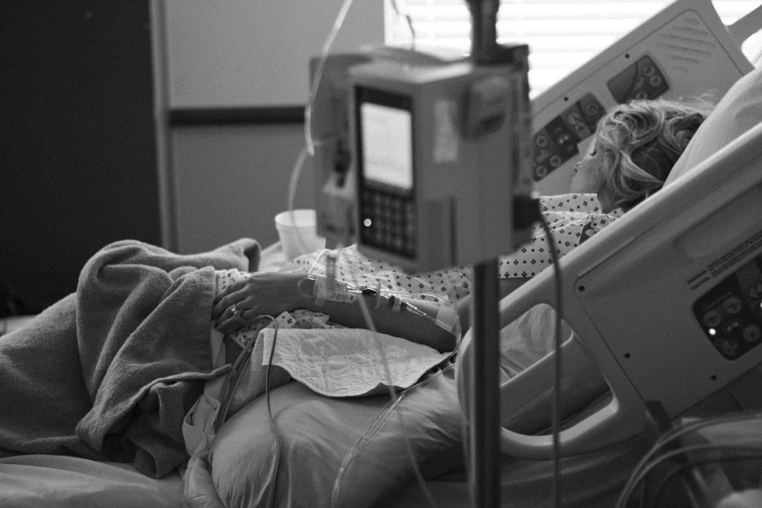 A photo of a woman in a hospital bed