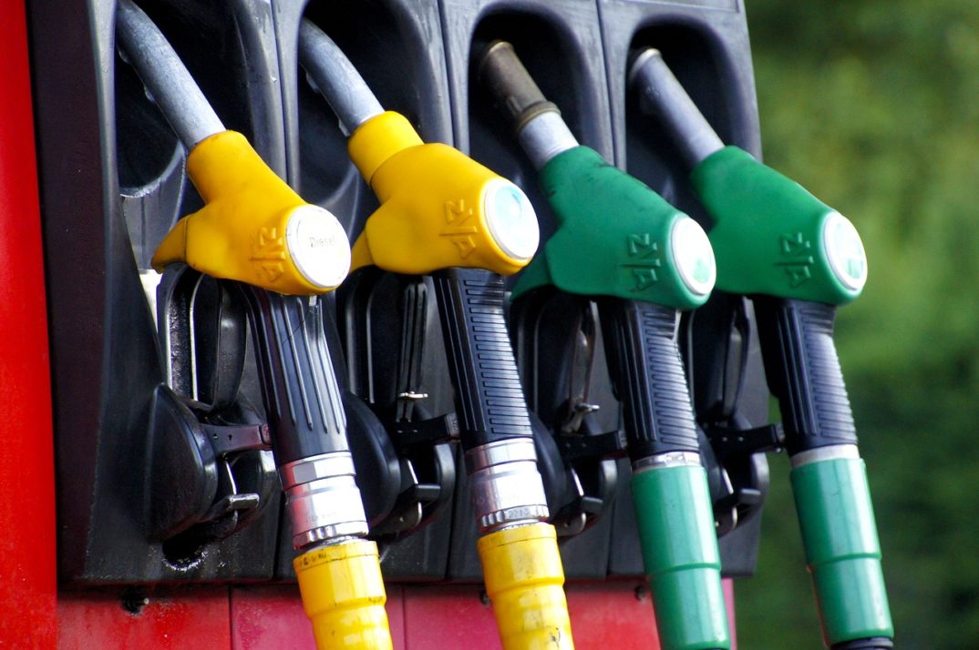 A row of multicolored gasoline tank nozzles