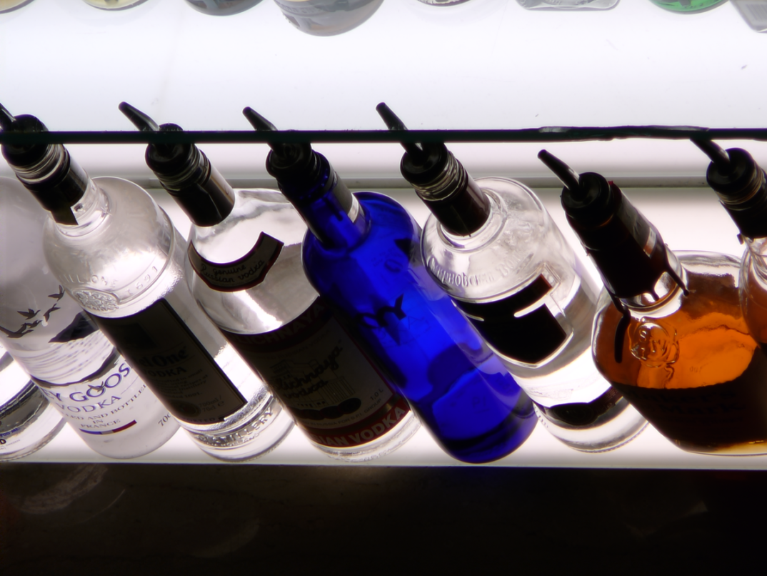 A photo of multicolored liquor bottles.