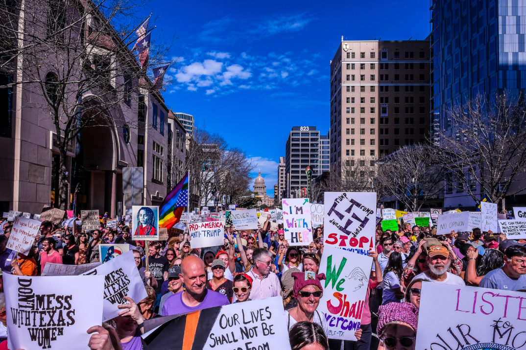 "Women's March Austin-1" by Lauren Harnett liscensed under CC BY 2.0 (via Flickr)