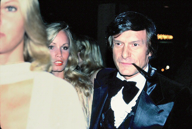 An old snapshot of Hugh Hefner smoking a pipe.