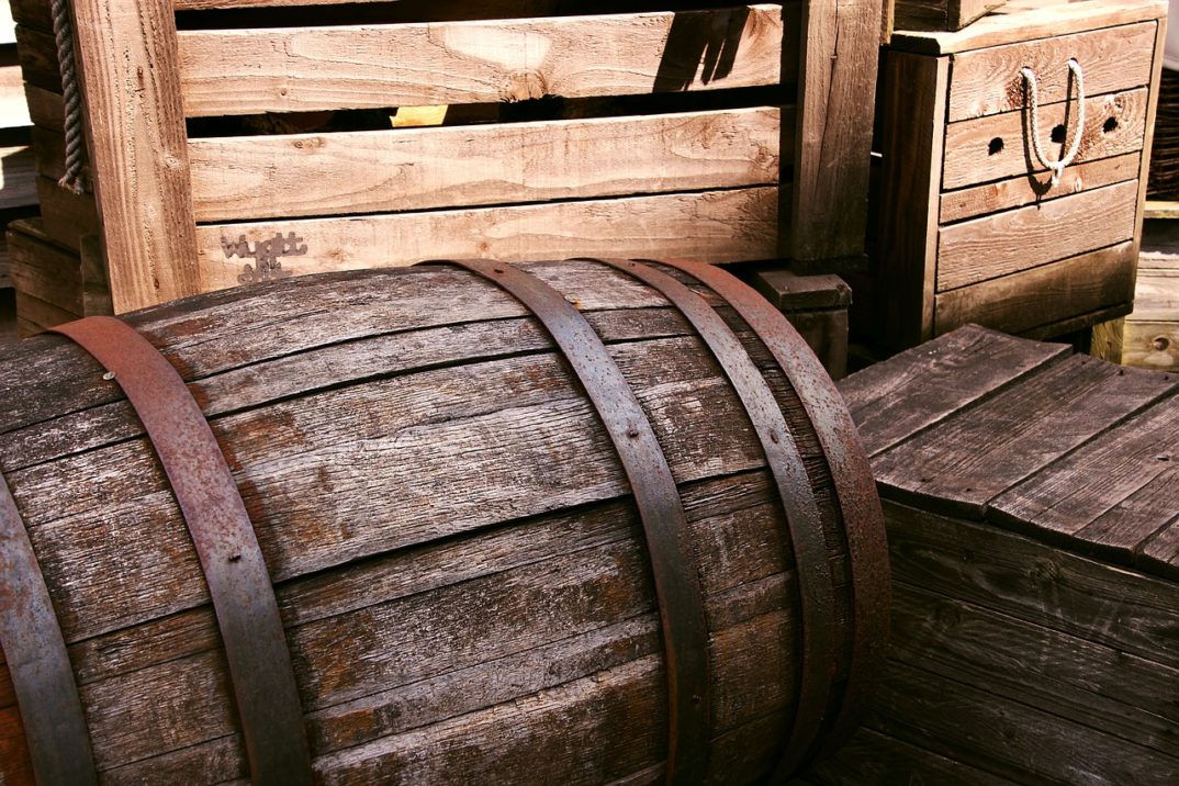A photo of an old, weathered wooden barrel.