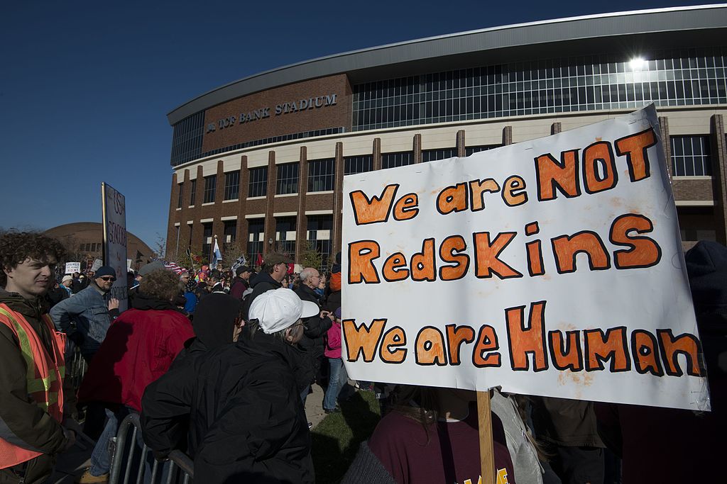 An image of a protest outside a Washington Redskins football game.
