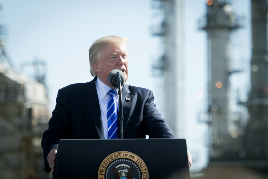 A photo of President Trump speaking behind a podium.