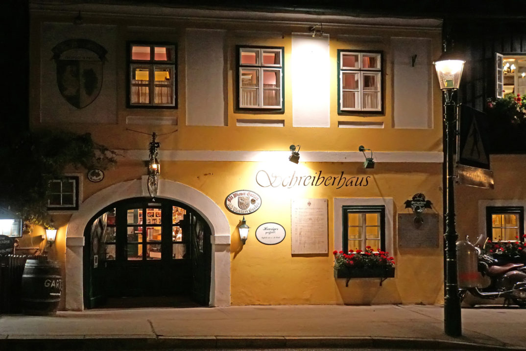 Photo of an Austrian restaurant/hotel lit by a streetlight