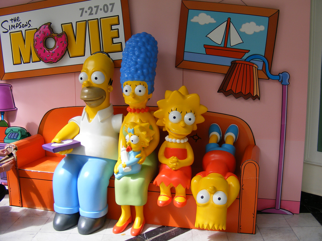 Image of plastic figures of Simpsons characters sitting on a couch