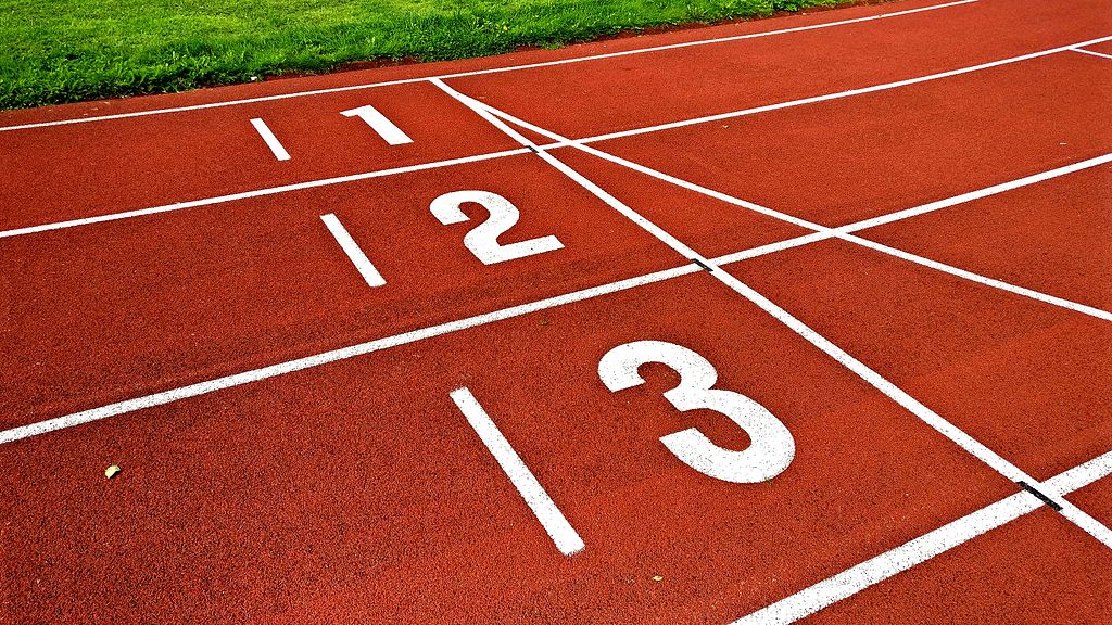 Image of numbers on the lanes of a running track.