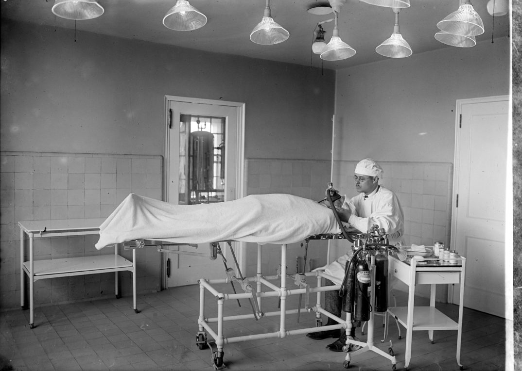 Doctor inspecting a patient on an operating table