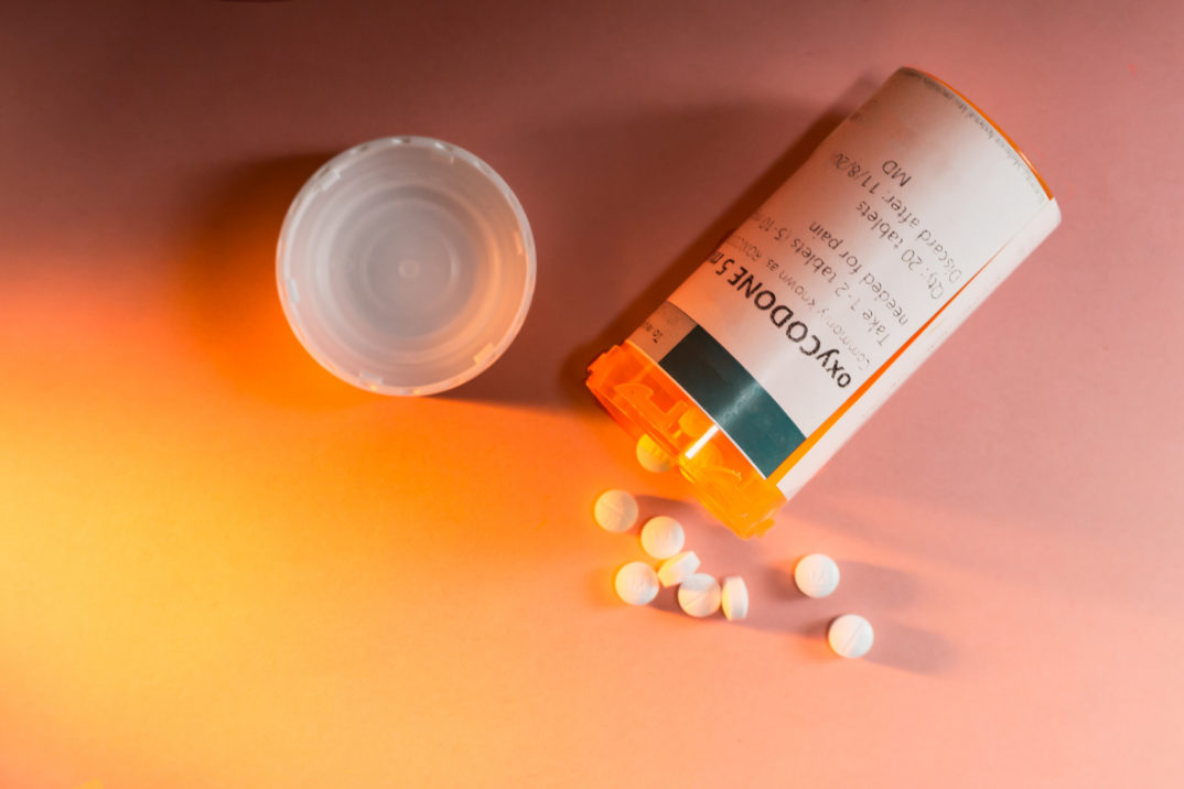photograph of a pill bottle with pills spilling out