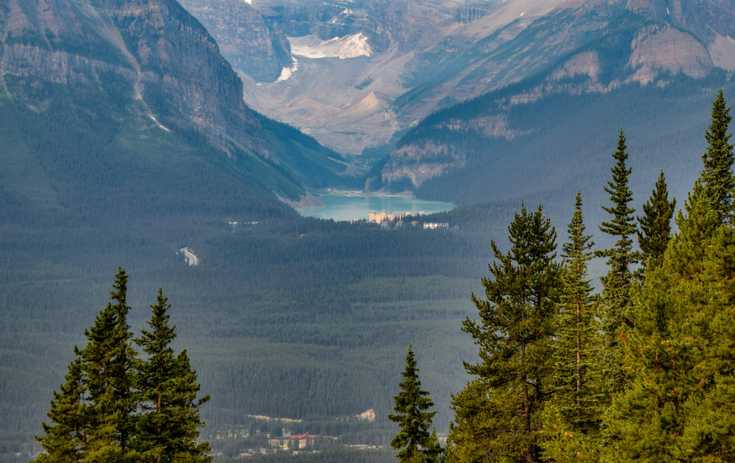 Photograph of mountains and trees framing a lake