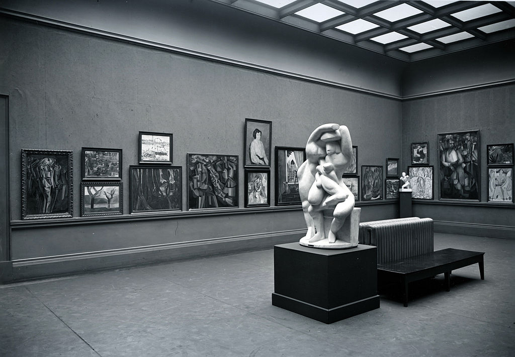 Black and white photograph of a cubist exhibition in a museum