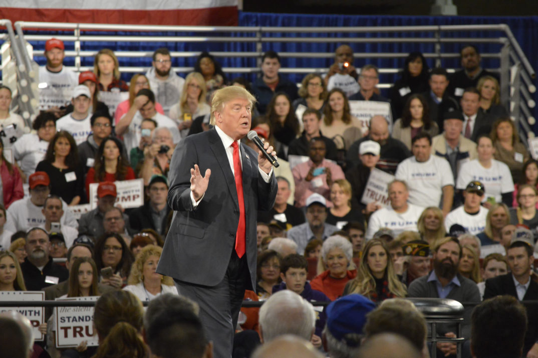 Photograph of Donald Trump speaking into a microphone