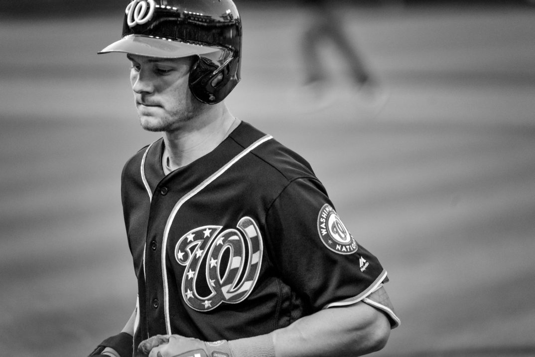 Black and white photograph of baseball player Area Turner walking off of the baseball field, glove in hand