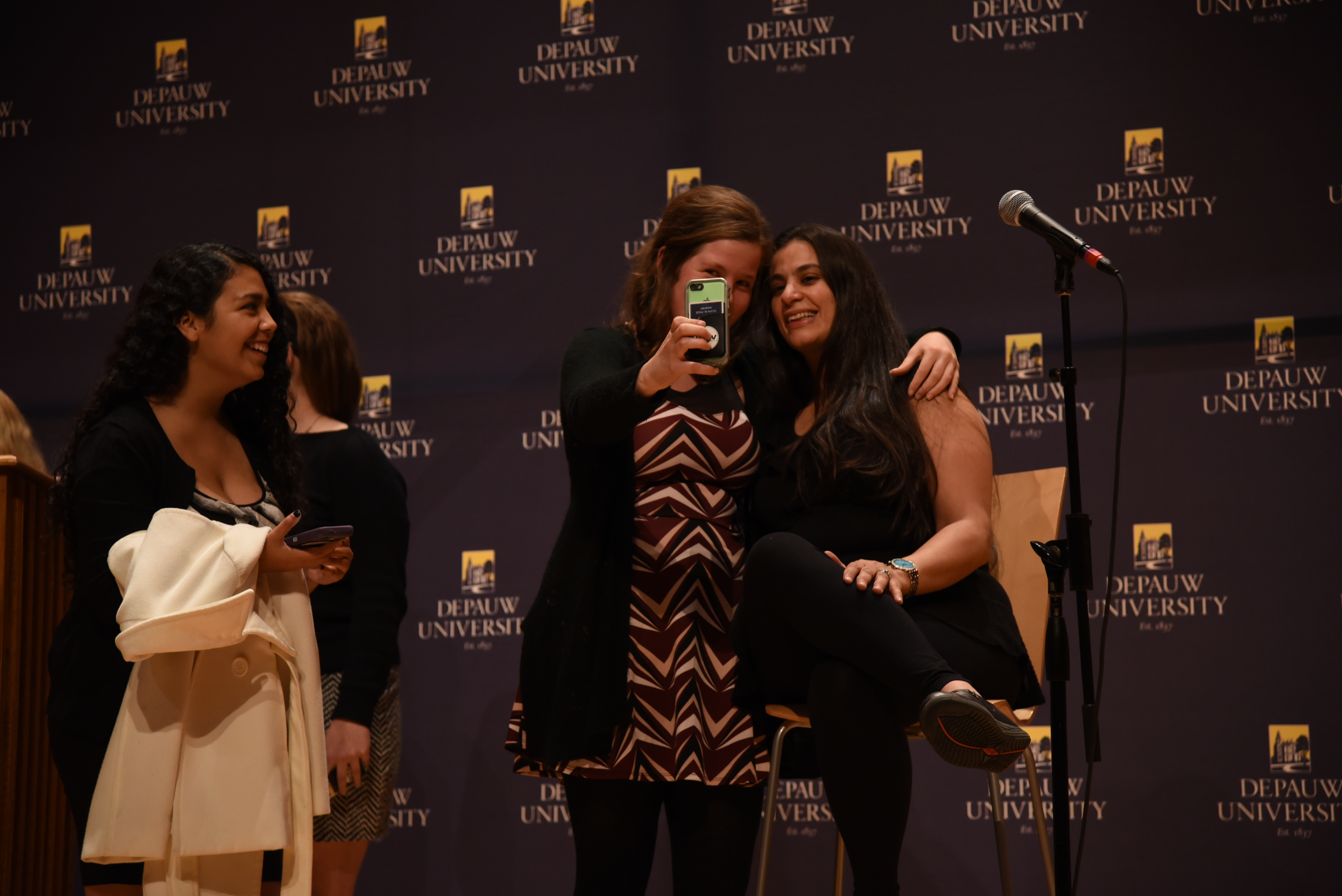 Mason Zayid taking a selfie with a DePauw student on stage