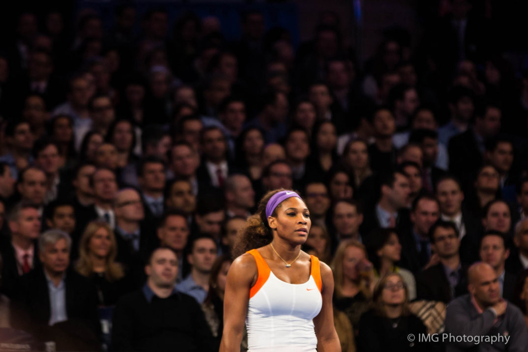 Photograph of tennis athlete Serena Williams with a crowd behind her