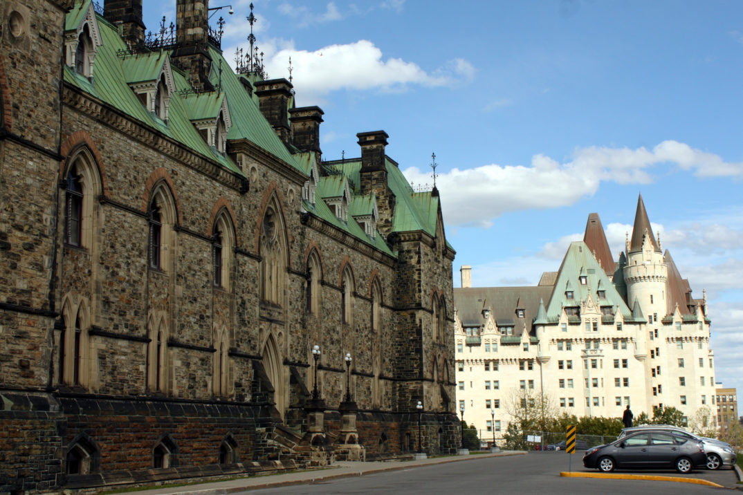 Photograph of the Canadian Parliament building in Ottawa with a hotel in the background