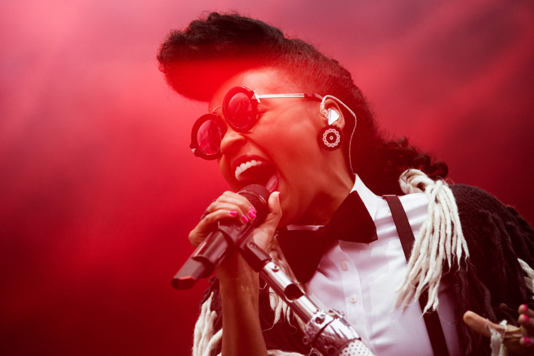 Photograph of singer Janelle Monáe holding a microphone
