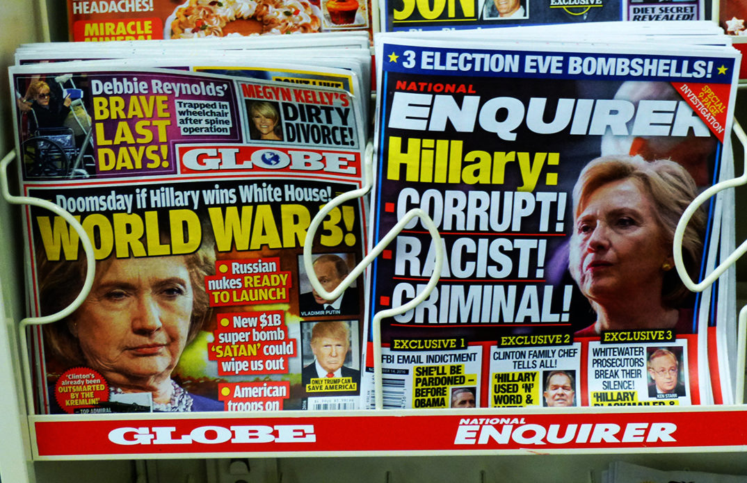 Photograph of two tabloid magazines with headlines about Hilary Clinton, dated "election eve," 2016