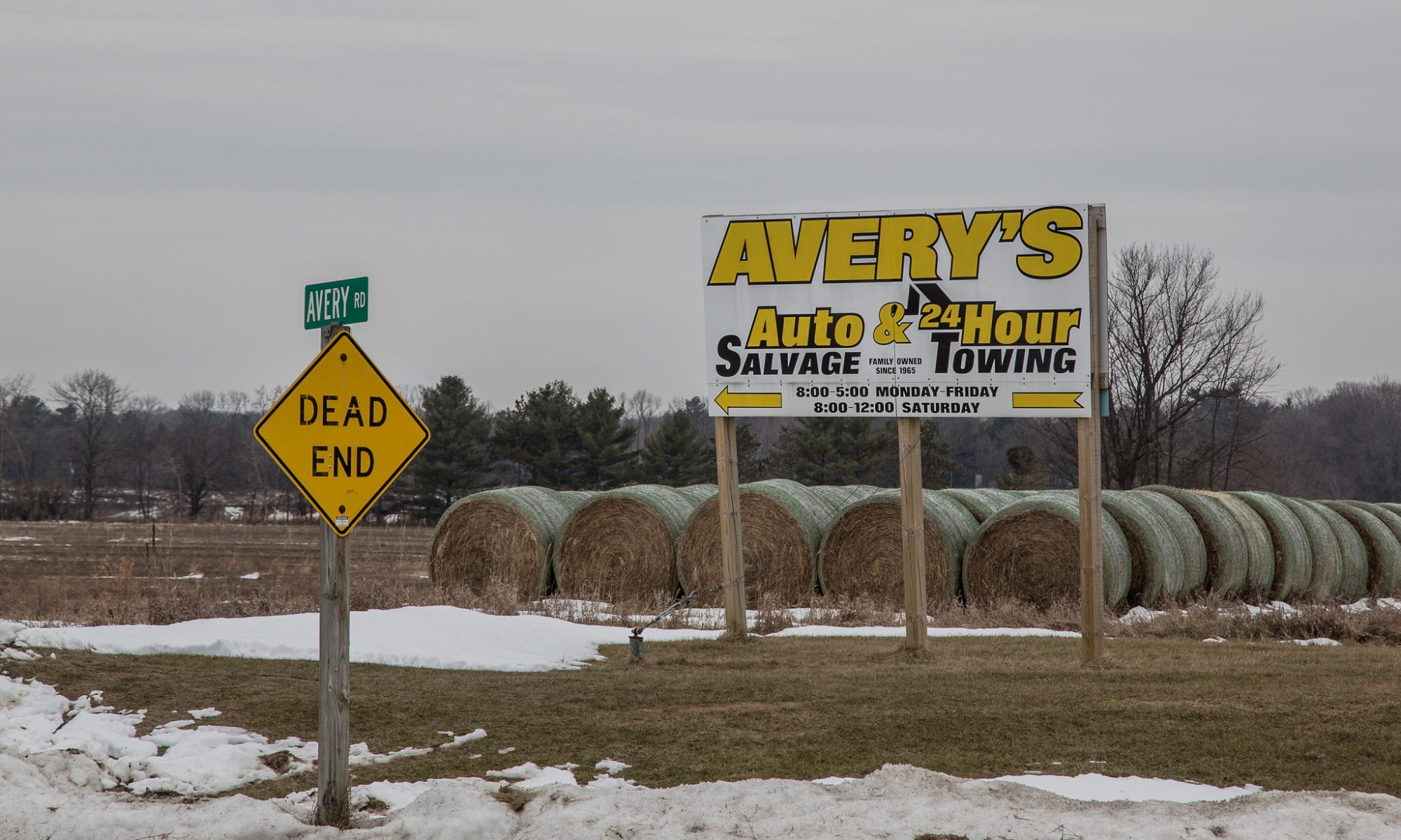 Photograph of a billboard that says Avery's Auto Salvage and 24-Hour Towing