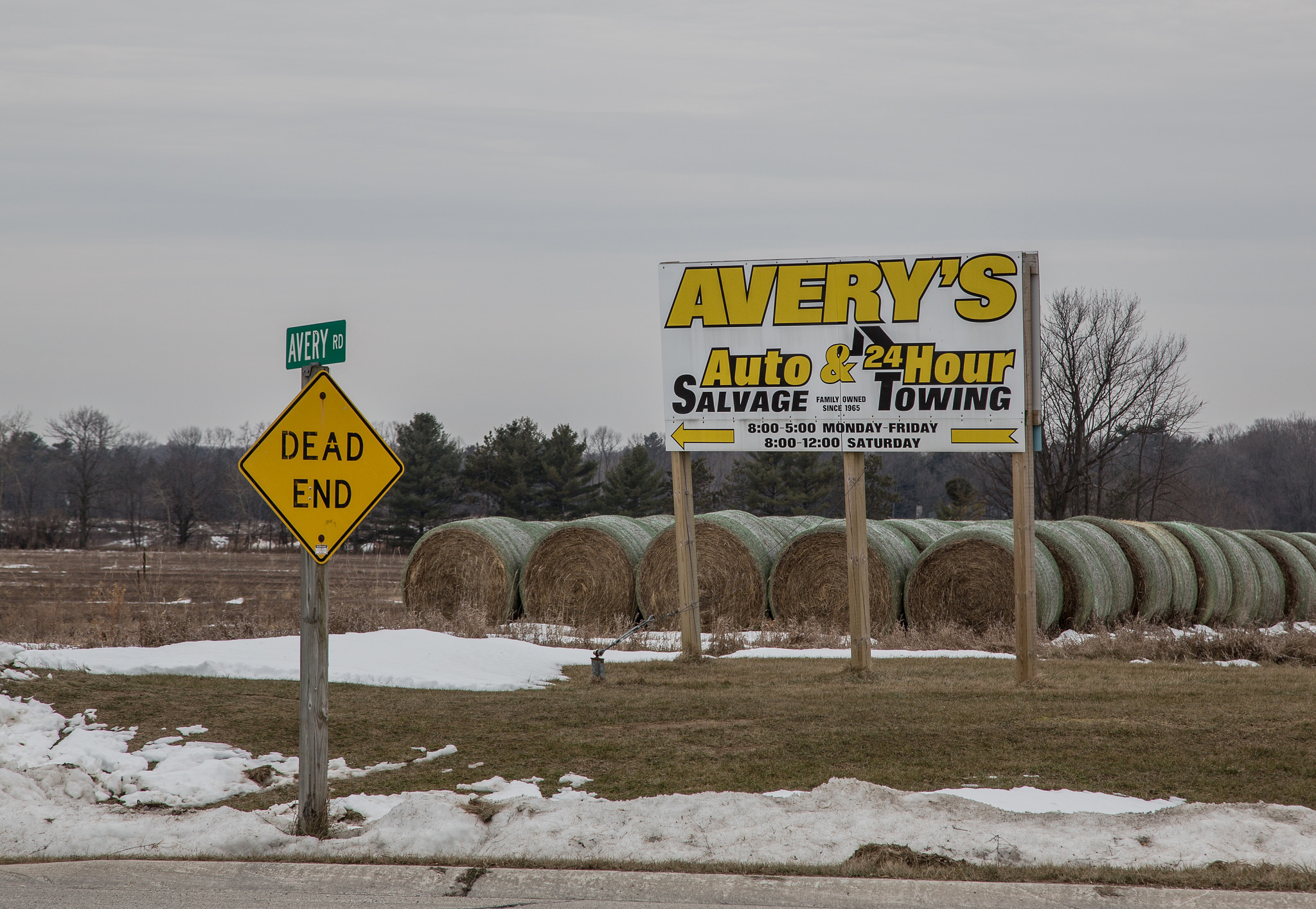 Photograph of a billboard that says Avery's Auto Salvage and 24-Hour Towing