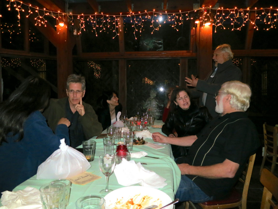Group of people gathered around a holiday table