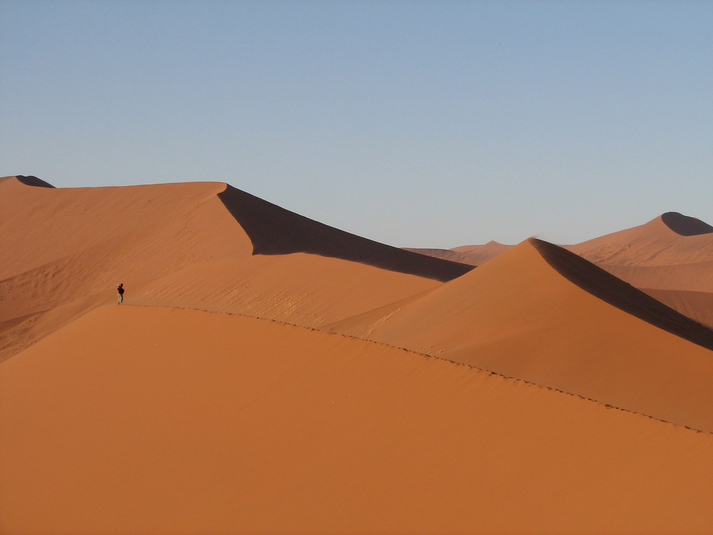 Namibian sand dunes outlined against blue sky