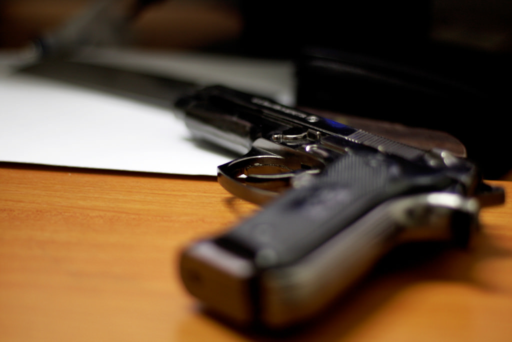 A photograph of a gun on a table
