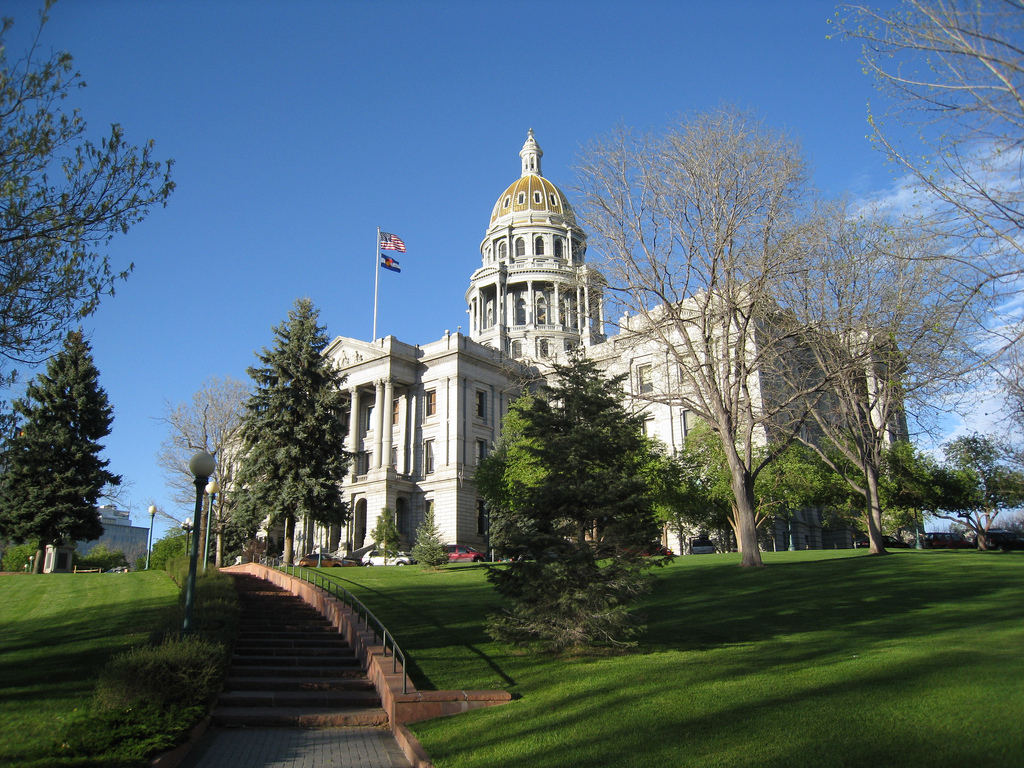 A photograph of the Colorado Capitol Building in Denver, with green grass and blue sky