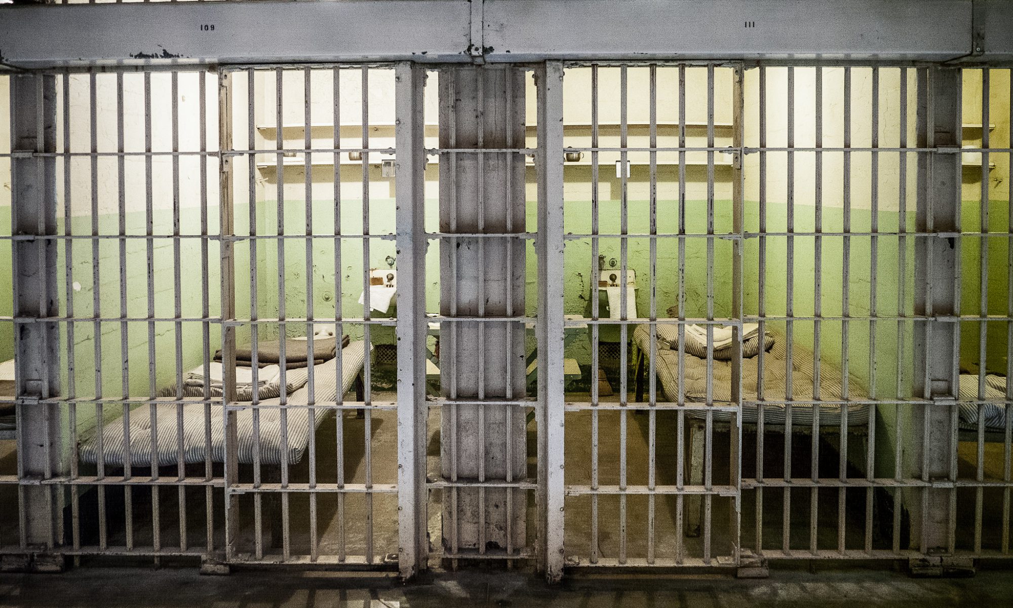 image of two adjoining prison cells