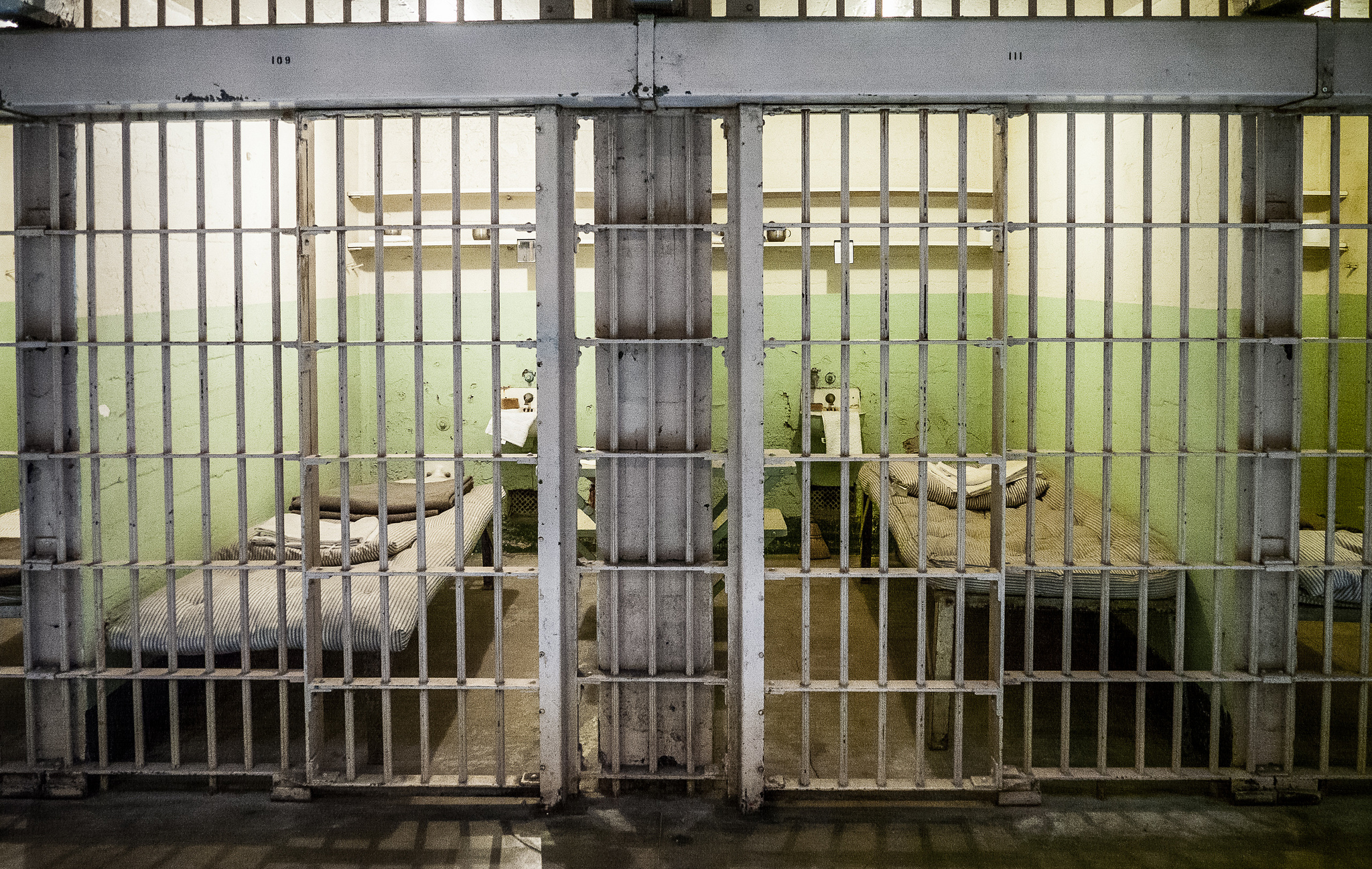 image of two adjoining prison cells