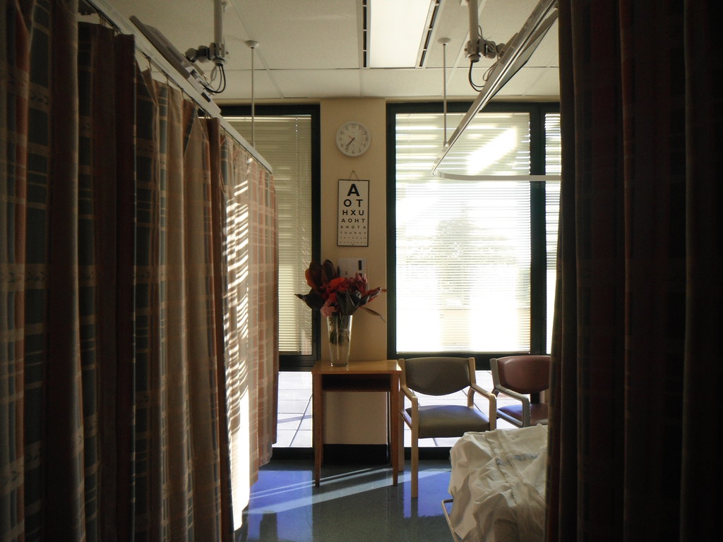 photograph of empty hospital room with flowers