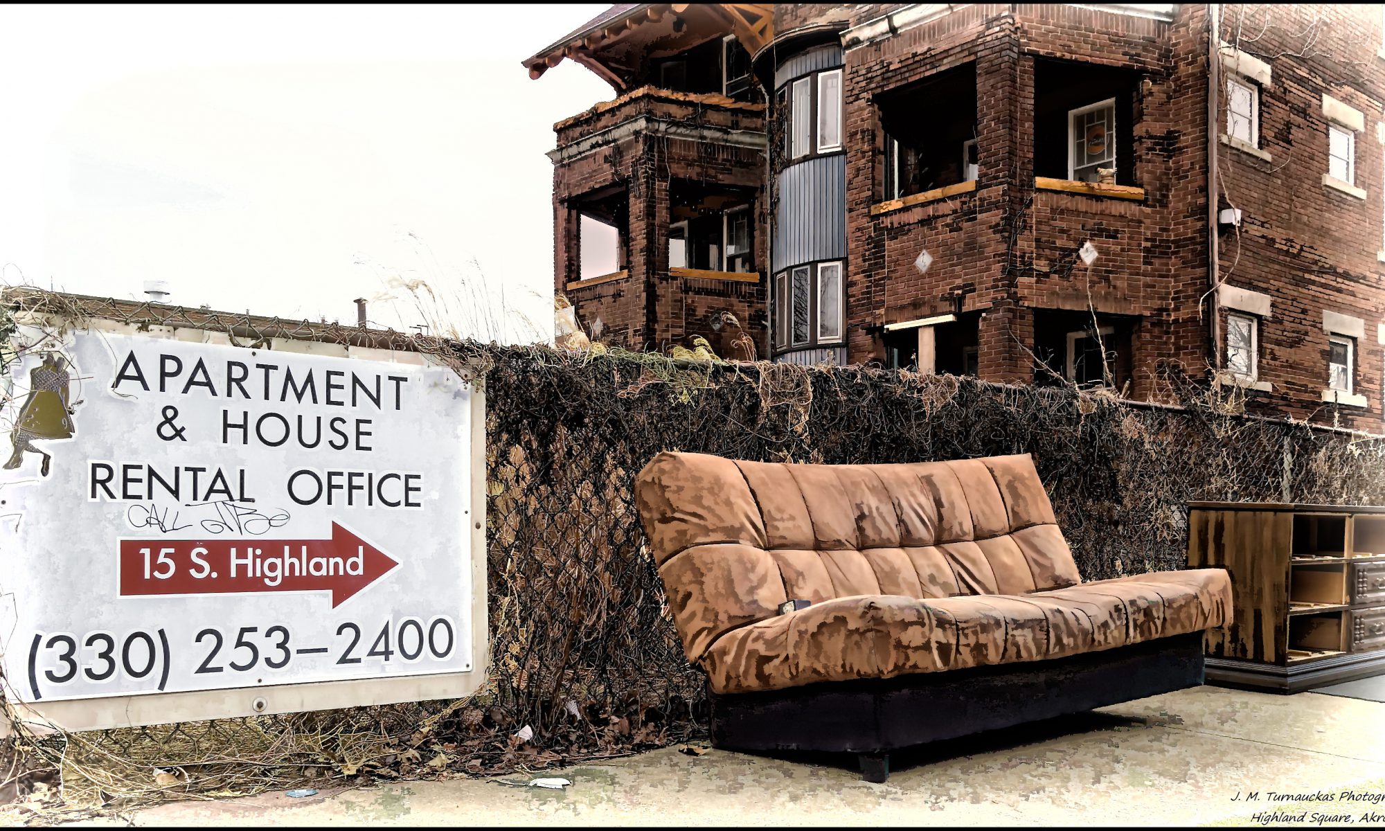 A couch sits below a rental office.