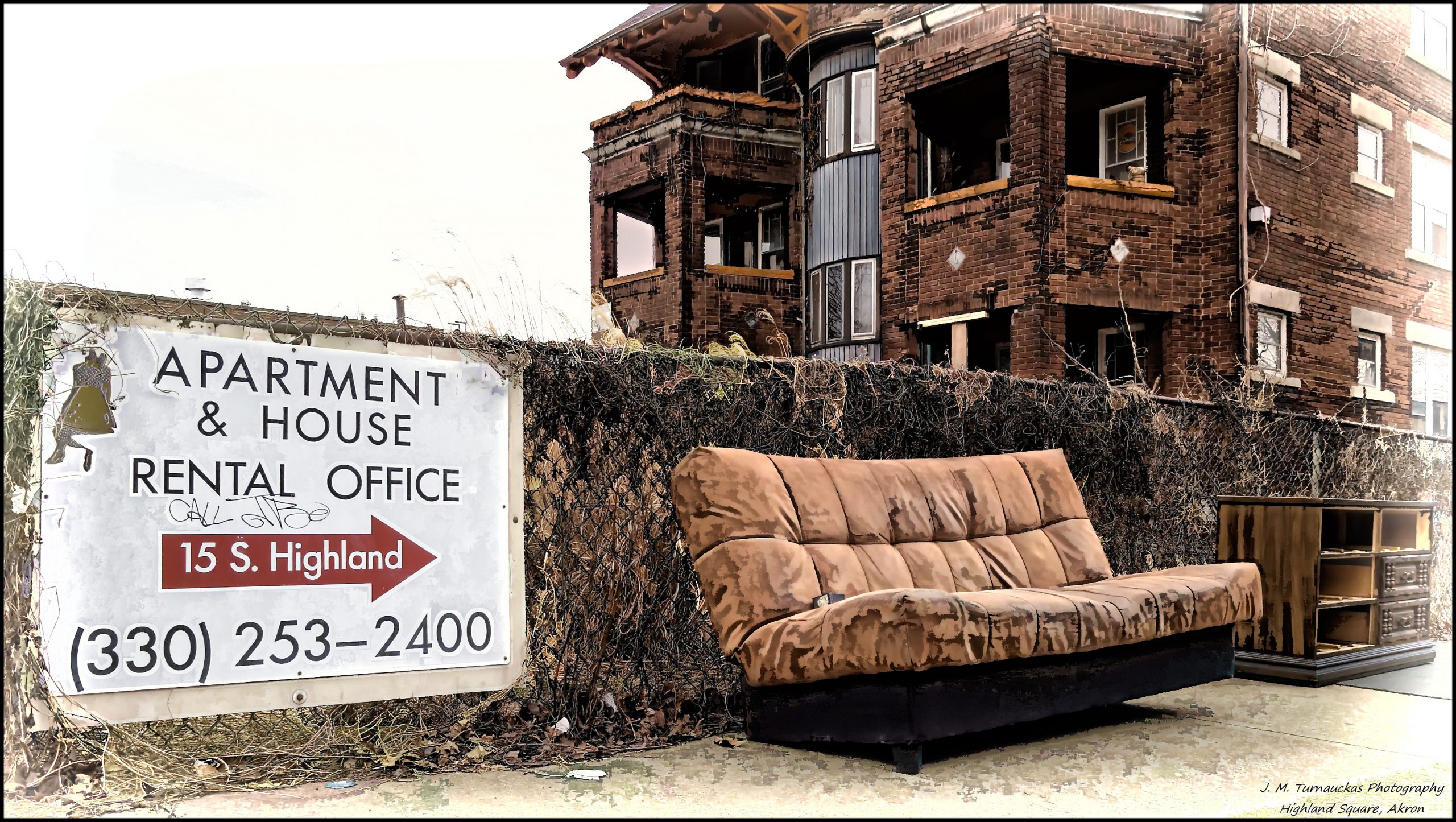 A couch sits below a rental office.