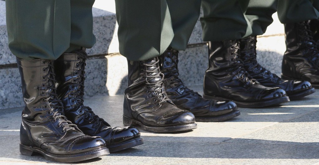 close-up photograph of the boots of four servicepeople