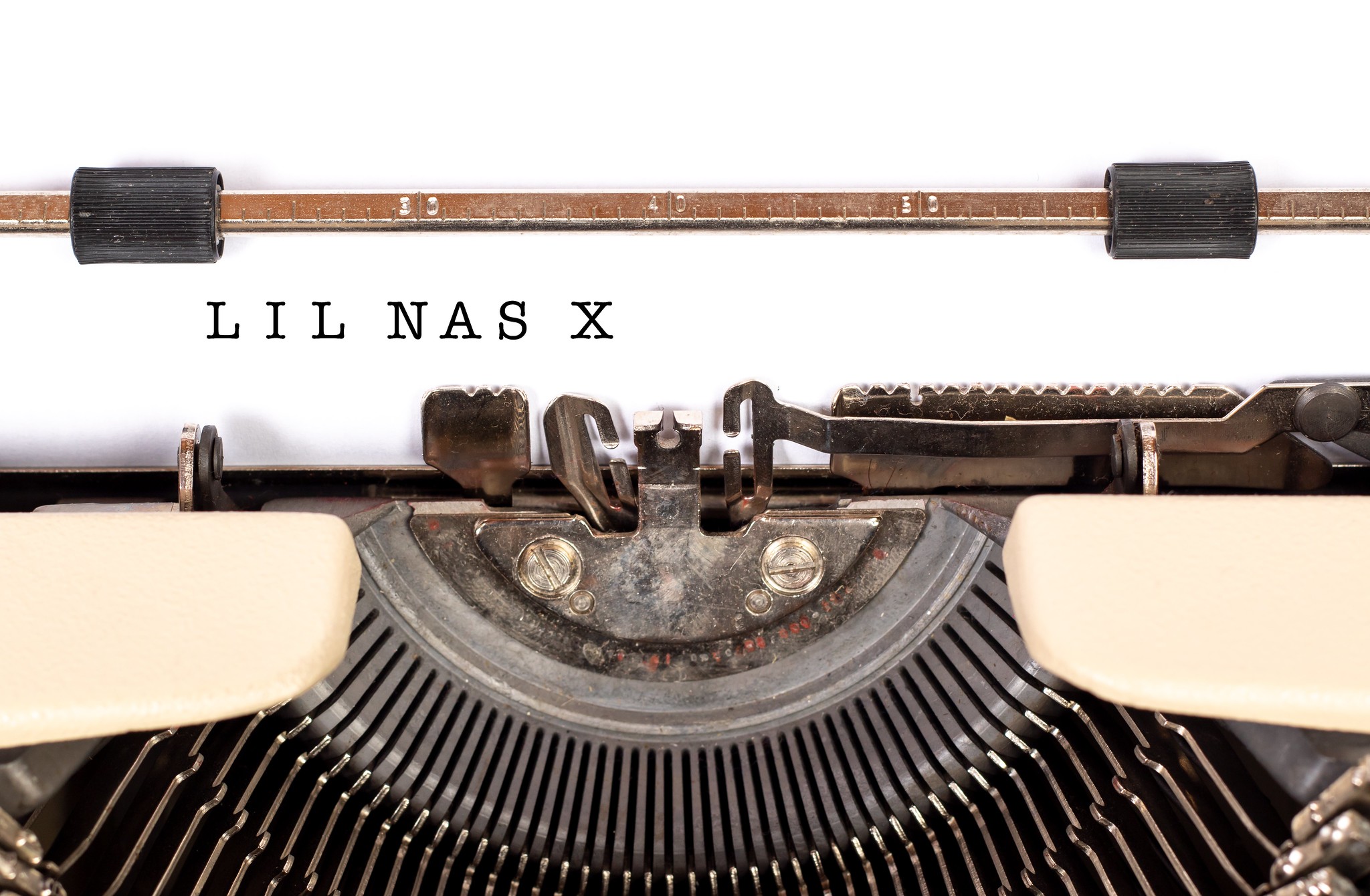 Photograph of a type writer with the words "Lil Nas X" having just been typed
