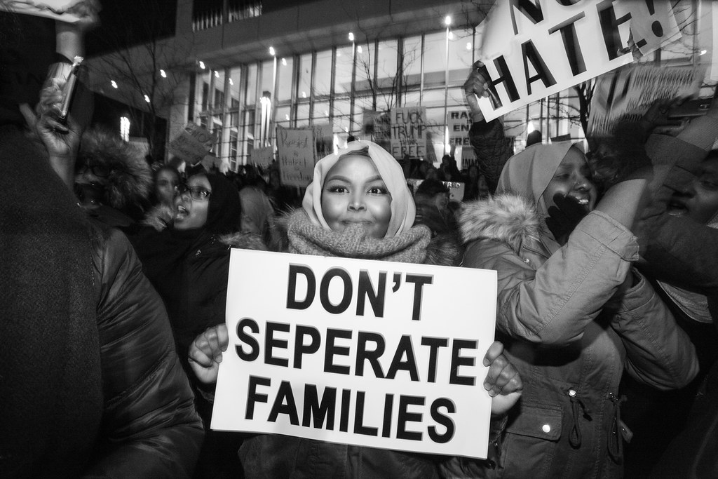 balck-and-white photograph of protester with "Don't Separate Families" sign