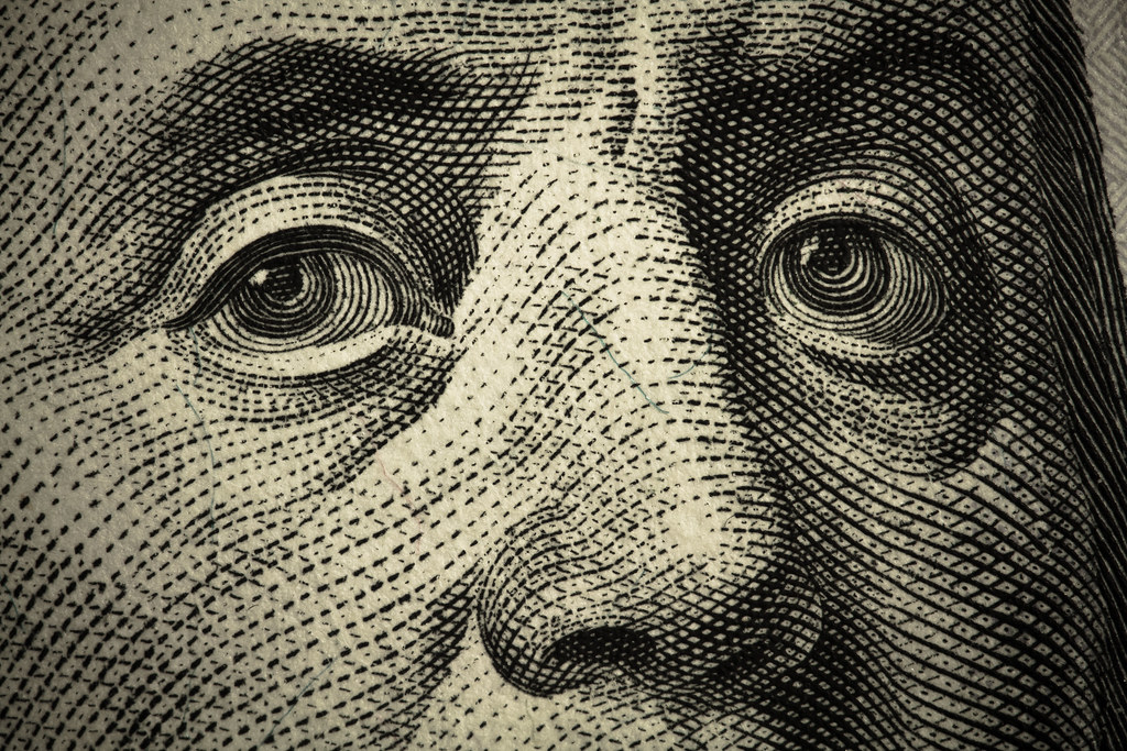 closeup photograph of Ben Franklin's face on $100 bill