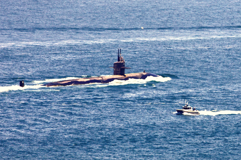 photograph of submarine half-submerged in ocean