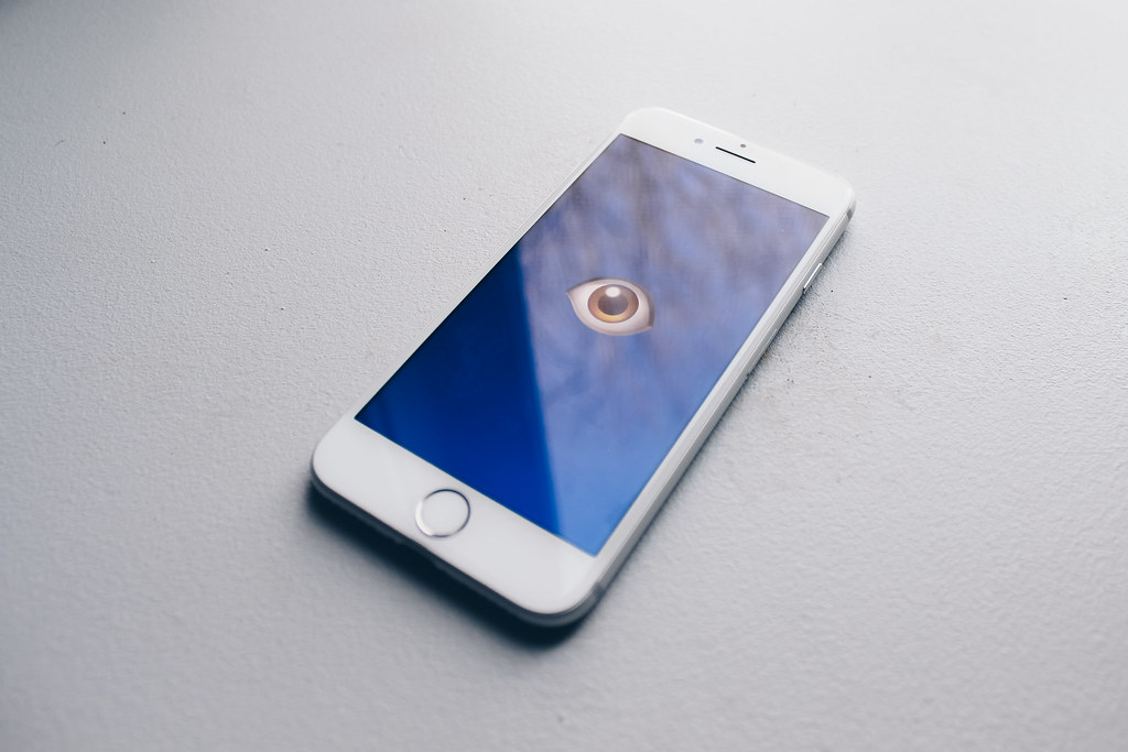 photograph of iphone with image of an eye on screen