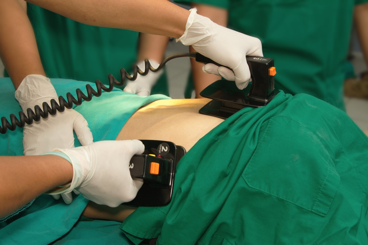 photograph of defibrillator practice on a CPR dummy