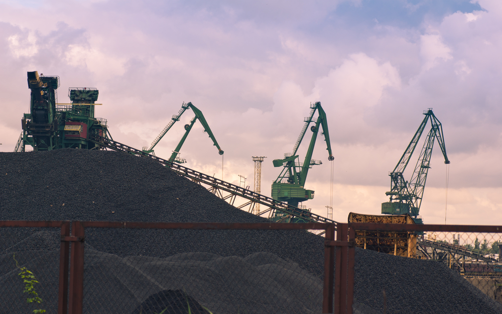 photograph of machines at a coal mine at dawn