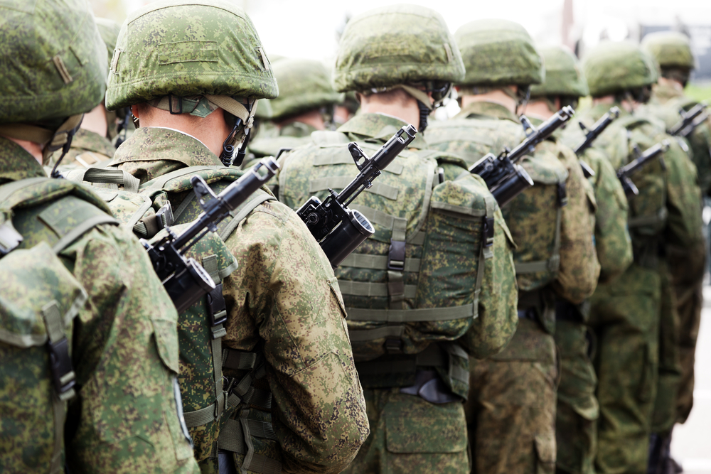 photograph of armed soldiers in file