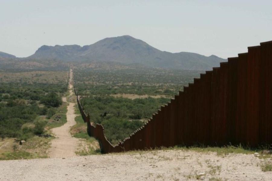 photograph of border wall stretching into the distance