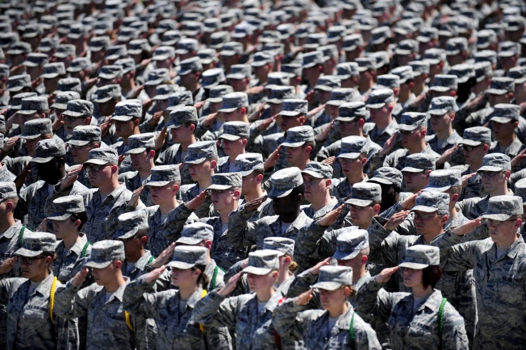 photograph of soldiers in uniform saluting