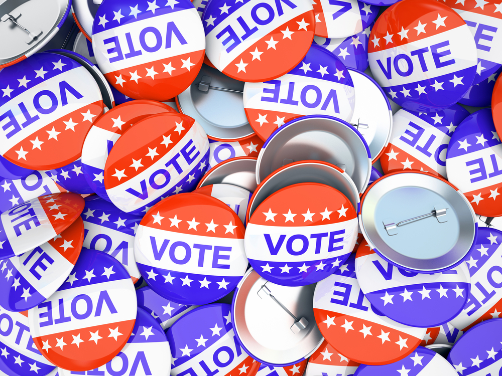photograph of pile of "Vote" buttons