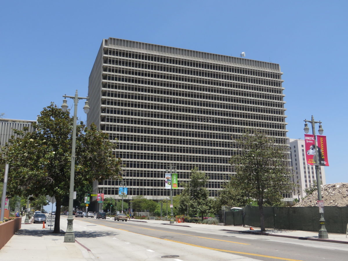 View from street of a large concrete building with thousands of windows. The building is the Los Angeles County Criminal Courts building.