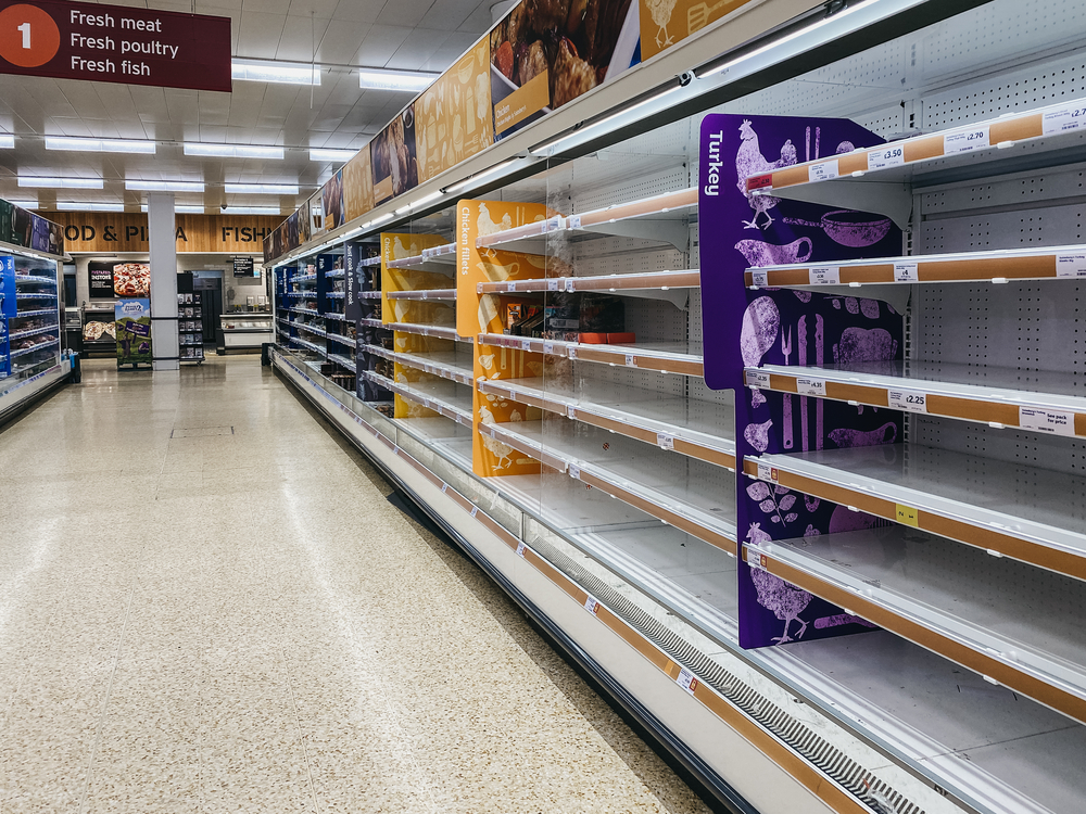 photograph of empty shelves at a grocery store