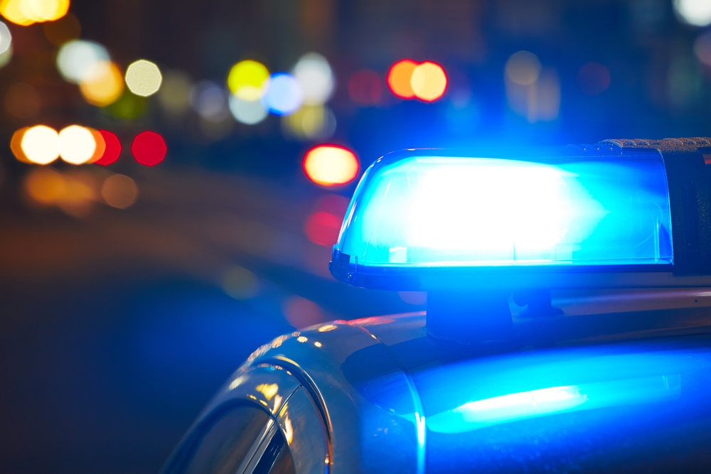 close-up photograph of police car on street at night
